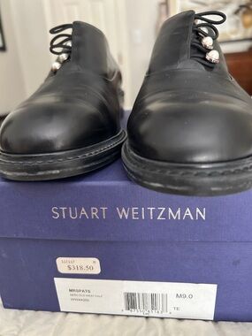 Stuart Weitzman black shoes with white pearl buttons